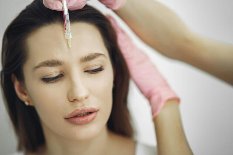 A botox procedure being performed on forehead of a woman